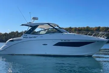 The Image of 2020 Sea Ray Sundancer 320 yacht on calm water under clear blue sky. - 0