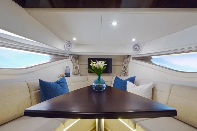 Slide: The Image of Manufacturer Provided Image: Interior of 2020 Sea Ray Sundancer 320 yacht with elegant seating and table. - 22