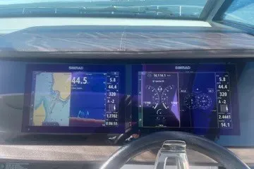 Slide: The Image of Dashboard of a 2020 Sea Ray Sundancer 320 with dual Simrad navigation displays. - 10