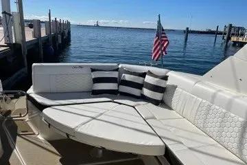 Slide: The Image of 2020 Sea Ray Sundancer 320 yacht with elegant seating, docked by the water. - 13