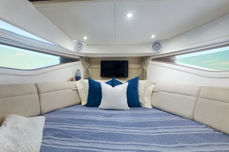 Slide: The Image of Manufacturer Provided Image: Interior cabin of 2020 Sea Ray Sundancer 320 with cozy bed and TV. - 23