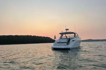 Slide: The Image of 2020 Sea Ray Sundancer 320 yacht on serene water at sunset. - 3