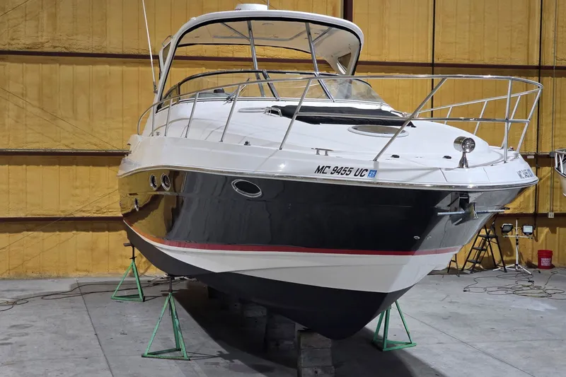 The Image of 2007 Regal Commodore 3760 IO boat in indoor storage, elevated on stands. - 0