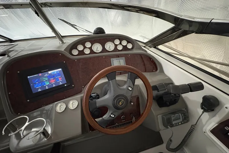 Slide: The Image of 2007 Regal Commodore 3760 IO boat dashboard with steering wheel and navigation controls. - 13