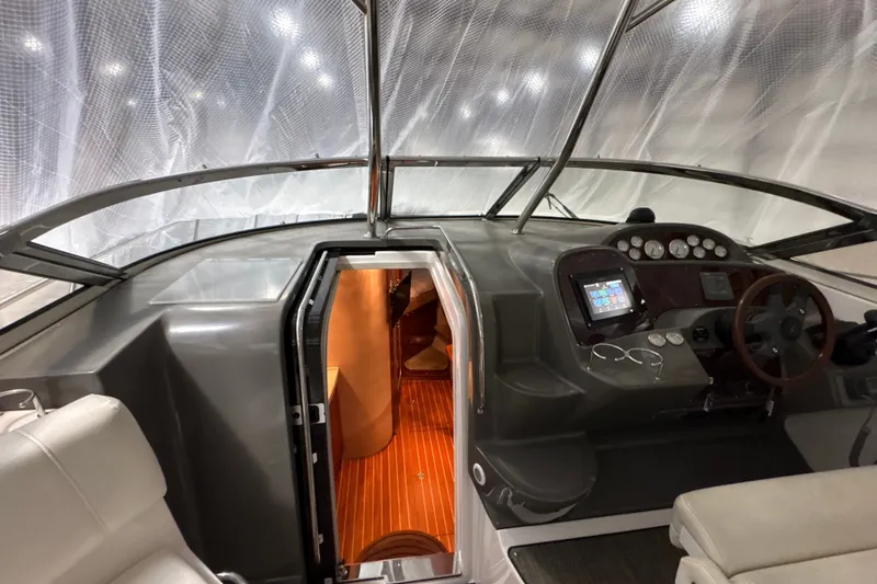Slide: The Image of 2007 Regal Commodore 3760 IO boat interior with helm, dashboard, and cabin entrance. - 16
