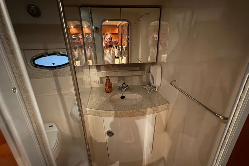 Slide: The Image of 2007 Regal Commodore 3760 IO bathroom with sink, mirror, and porthole window. - 25
