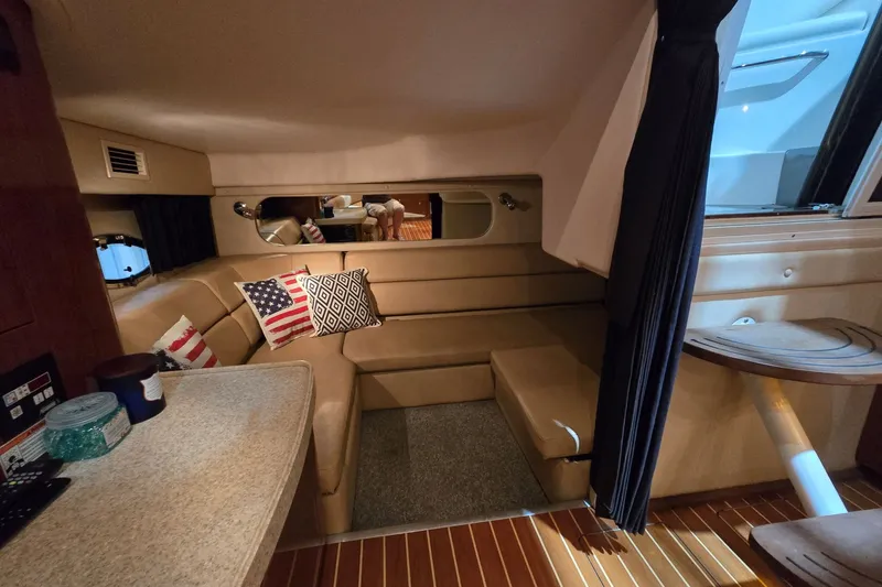 Slide: The Image of Interior of 2007 Regal Commodore 3760 IO yacht with cozy seating and decorative pillows. - 18