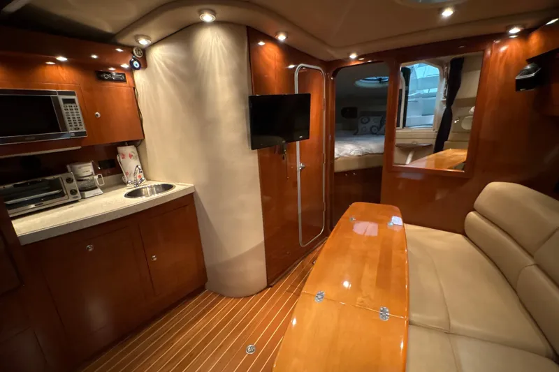 Slide: The Image of Luxurious interior of 2007 Regal Commodore 3760 IO yacht with kitchenette and seating area. - 22