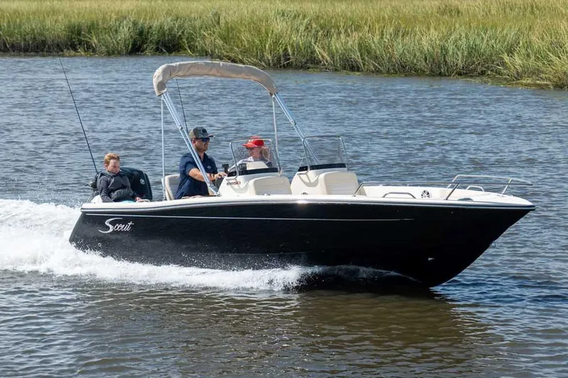 Slide: The Image of Manufacturer Provided Image: 2026 Scout 188 Sport Dorado boat cruising on a river with passengers. - 0