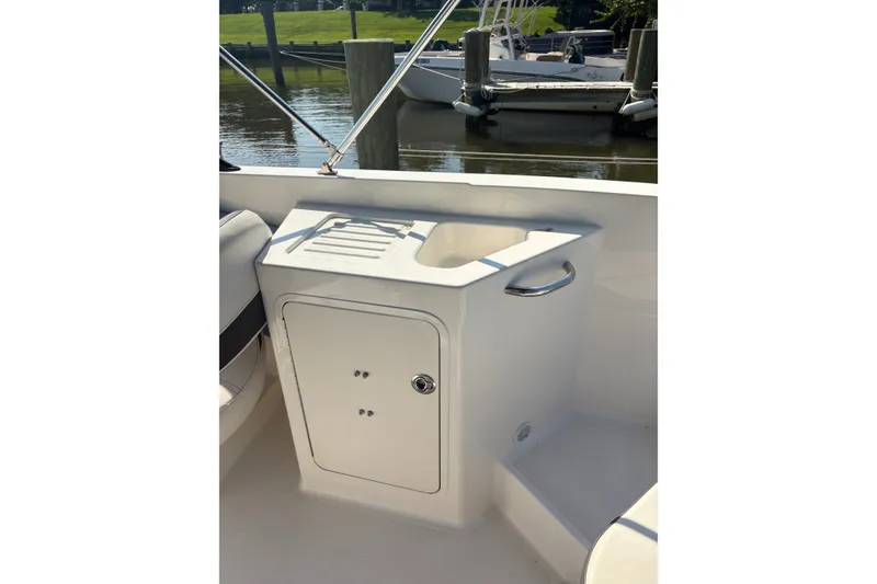 Slide: The Image of 2023 Bayliner DX 2200 boat interior with sink and storage compartment. - 9