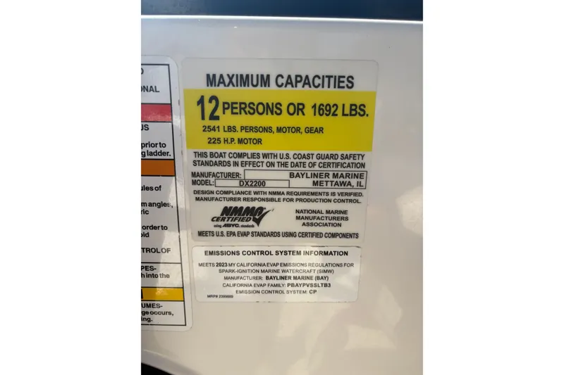 Slide: The Image of 2023 Bayliner DX 2200 capacity label: 12 persons or 1692 lbs, 225 HP motor. - 8