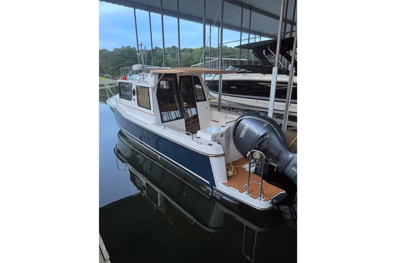 The Image of 2022 Ranger Tugs R-25 boat docked, featuring a Yamaha outboard motor. - 2