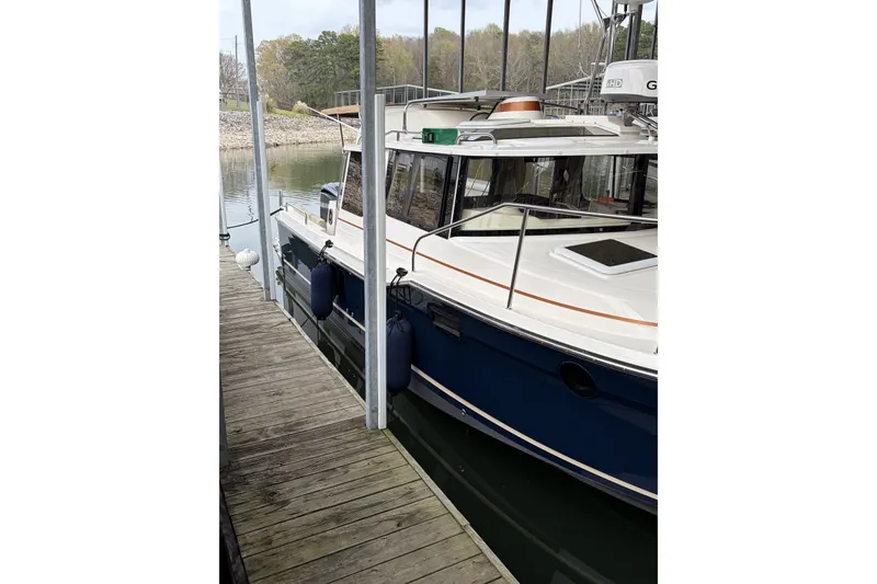 Slide: The Image of 2022 Ranger Tugs R-25 docked, featuring sleek design and modern amenities. - 3