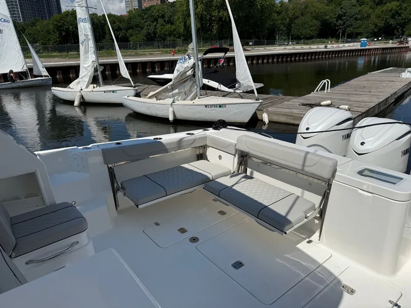Slide: The Image of The image shows the cockpit of a 2027 Pursuit OS 355 Offshore with foldable seats and engines. - 10