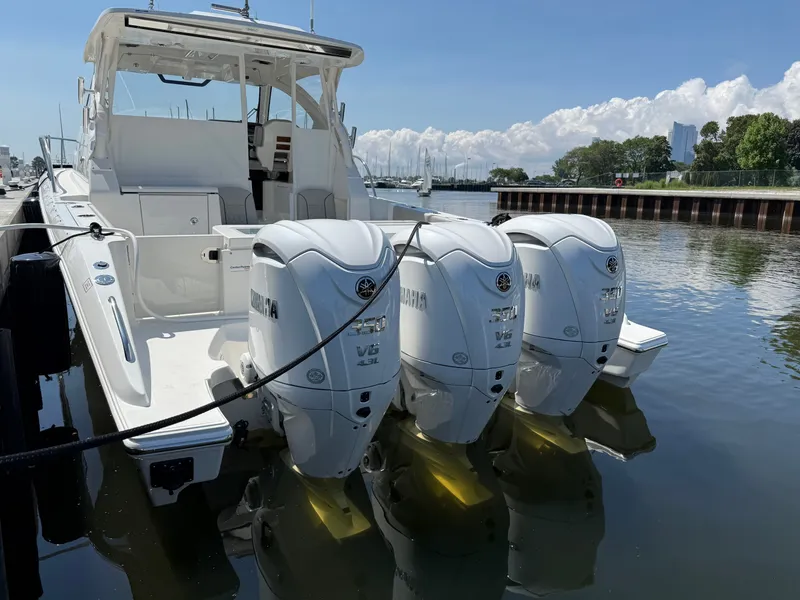 Slide: The Image of A 2027 Pursuit OS 355 Offshore with three Yamaha V8 engines docked at the pier. - 6