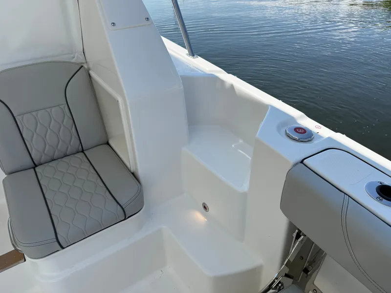 Slide: The Image of The image shows the seating area of a Pursuit OS 355 Offshore boat with gray upholstery. - 15