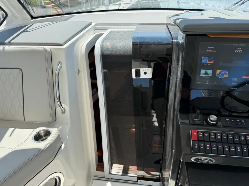 Slide: The Image of The image shows the cockpit of a Pursuit OS 355 Offshore with modern instruments and a comfortable seat. - 26