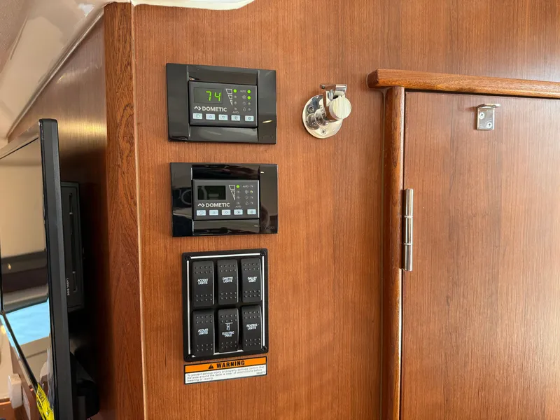Slide: The Image of The interior view shows a control panel with multiple switches and displays on wood paneling. - 34