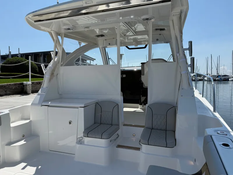 Slide: The Image of The image shows the cockpit of a 2027 Pursuit OS 355 Offshore with gray seating. - 12