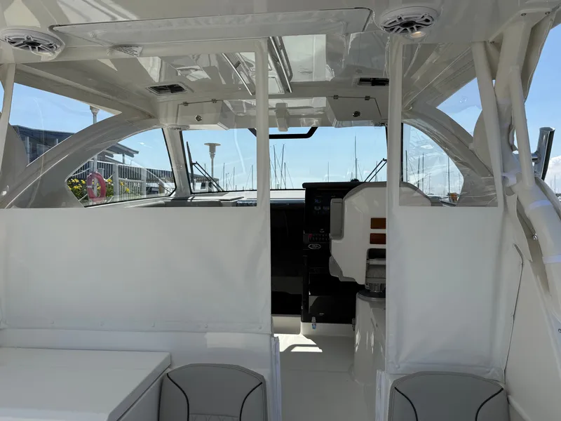 Slide: The Image of Interior view of a modern yacht with white seating and large windows overlooking a marina. - 17