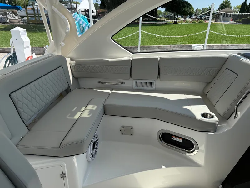 Slide: The Image of The image shows the interior of a 2027 Pursuit OS 355 Offshore boat with sleek, cushioned seating. - 22