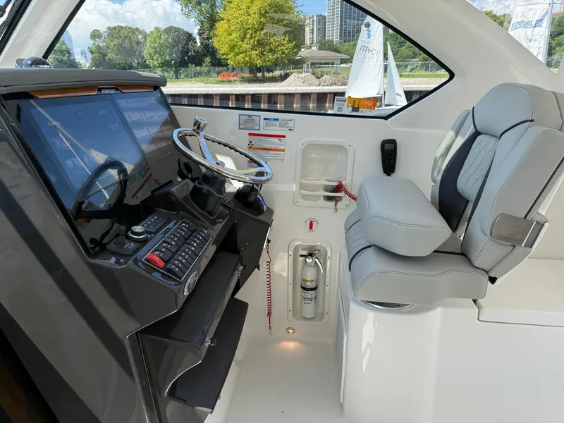 Slide: The Image of The cockpit of the Pursuit OS 355 Offshore features a modern helm and a comfortable seat. - 21