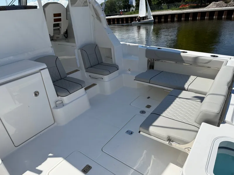 Slide: The Image of The image shows the cockpit of a Pursuit OS 355 Offshore with gray seating and a fold-out table. - 9