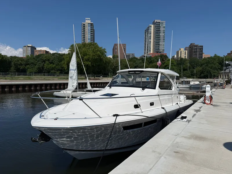 Slide: The Image of A white boat is docked in an urban harbor with high-rise buildings in the background. - 1