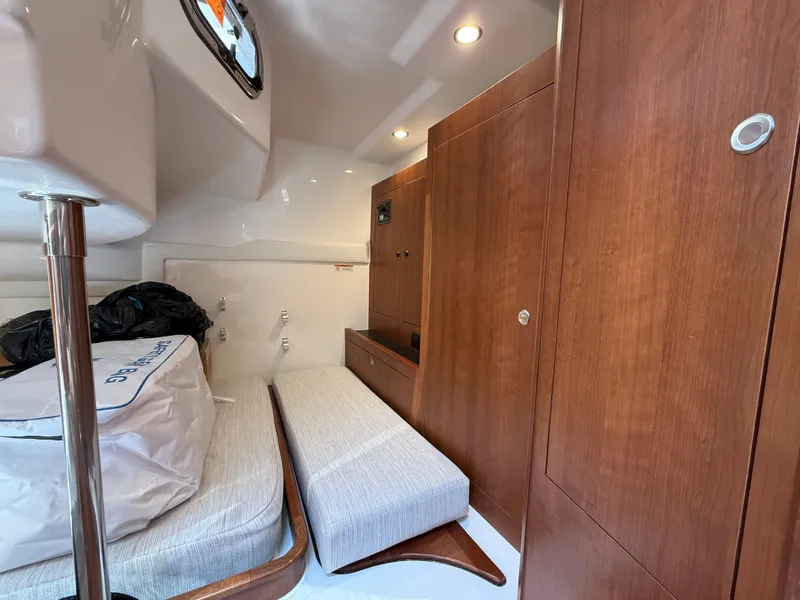 Slide: The Image of Interior of a 2027 Pursuit OS 355 Offshore with wooden cabinetry and upholstery. - 37