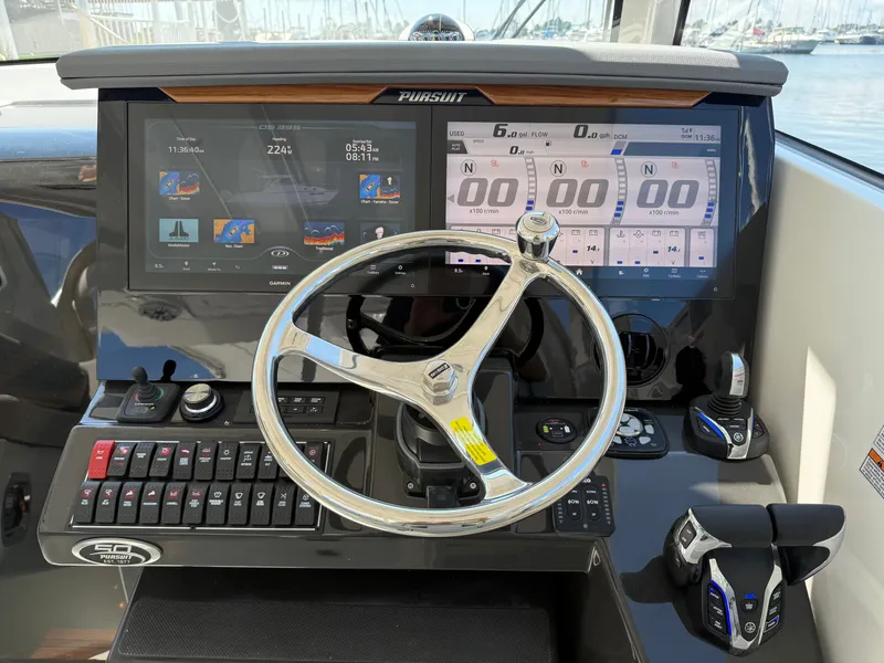 Slide: The Image of The image shows the helm of a Pursuit OS 355 Offshore boat with modern instruments. - 20