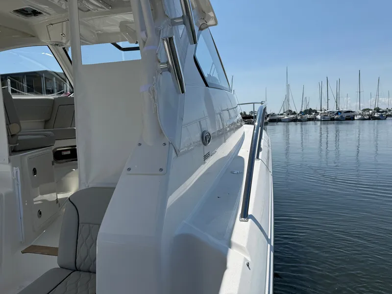 Slide: The Image of The 2027 Pursuit OS 355 Offshore is docked. View of the deck and seating area. - 16