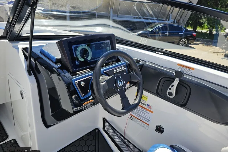 Slide: The Image of 2022 Scarab 255 Wake ID boat dashboard with steering wheel and digital display. - 72