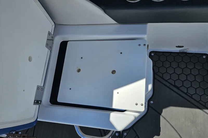 Slide: The Image of 2022 Scarab 255 Wake ID boat interior storage compartment with hexagonal floor mat design. - 49
