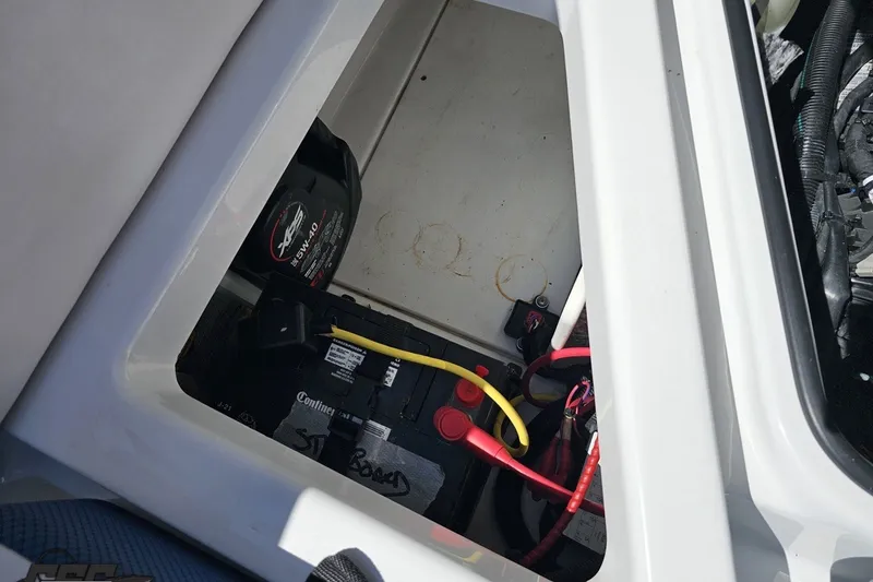 Slide: The Image of Battery compartment of 2022 Scarab 255 Wake ID boat with wiring and accessories. - 119