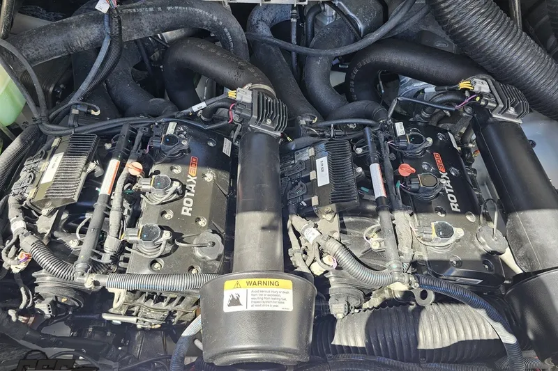 Slide: The Image of Engine compartment of a 2022 Scarab 255 Wake ID boat, featuring dual Rotax engines. - 117
