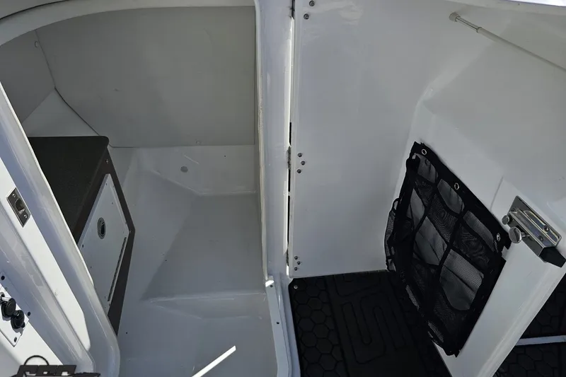 Slide: The Image of Interior cabin of 2022 Scarab 255 Wake ID boat, featuring storage and seating area. - 66