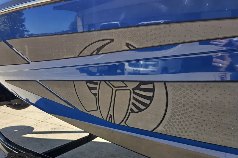 Slide: The Image of 2022 Scarab 255 Wake ID boat with blue and gray design details. - 26
