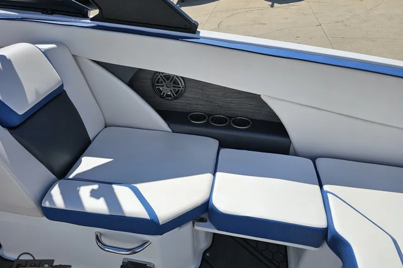 Slide: The Image of Interior seating of 2022 Scarab 255 Wake ID boat with blue and white upholstery. - 45