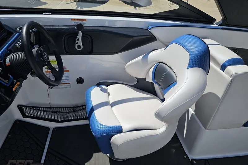 Slide: The Image of Interior of 2022 Scarab 255 Wake ID boat featuring a sleek steering wheel and cushioned seating. - 69