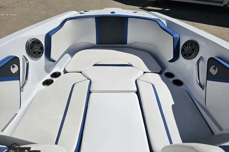 Slide: The Image of 2022 Scarab 255 Wake ID boat interior with white and blue seating, cup holders, and speakers. - 86