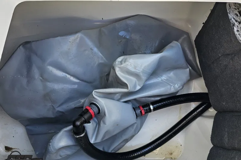 Slide: The Image of 2022 Scarab 255 Wake ID boat interior with gray tubing and black hose. - 48