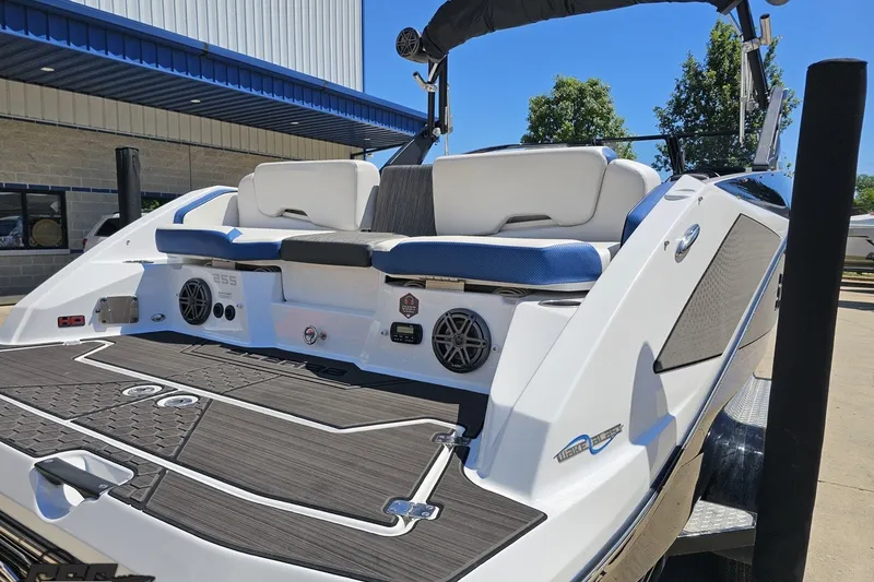 Slide: The Image of 2022 Scarab 255 Wake ID boat with sleek design and modern features, docked outdoors. - 32