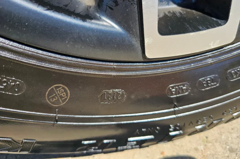 Slide: The Image of Close-up of a 2022 Scarab 255 Wake ID tire with embossed markings. - 121