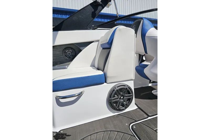 Slide: The Image of 2022 Scarab 255 Wake ID boat interior with blue and white seating and speaker system. - 58