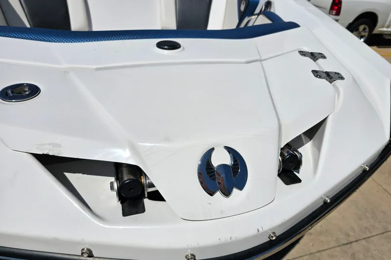 Slide: The Image of 2022 Scarab 255 Wake ID boat, white exterior with blue accents, close-up view. - 125