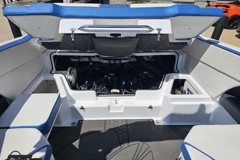 Slide: The Image of 2022 Scarab 255 Wake ID boat engine compartment with open hatch, showcasing interior components. - 114