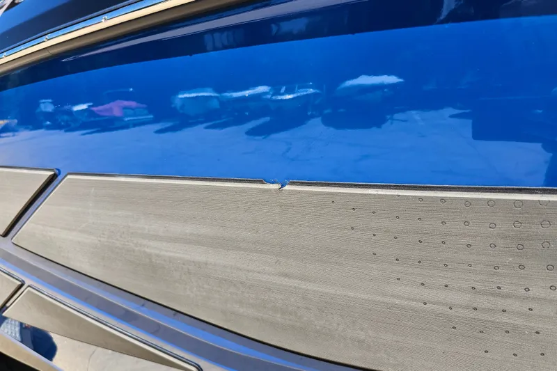 Slide: The Image of Close-up of 2022 Scarab 255 Wake ID boat hull with blue and gray detailing. - 123