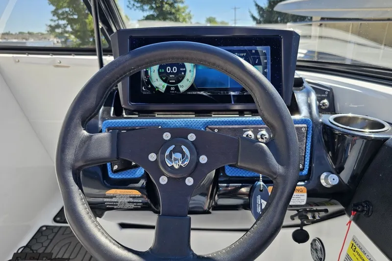 Slide: The Image of Steering wheel and dashboard of 2022 Scarab 255 Wake ID boat with digital display. - 76