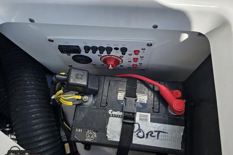 Slide: The Image of Battery compartment of 2022 Scarab 255 Wake ID boat with control panel and wiring. - 118