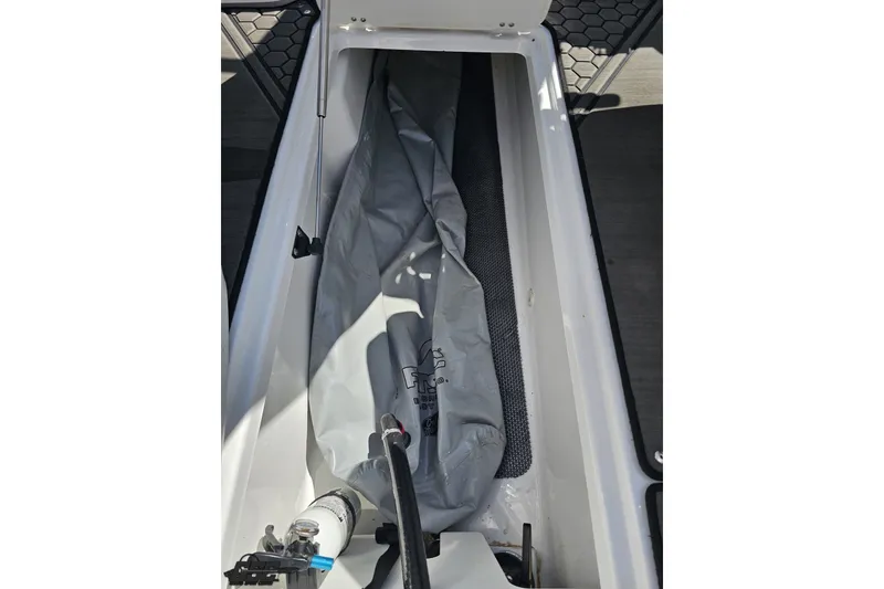 Slide: The Image of Storage compartment of 2022 Scarab 255 Wake ID boat with equipment inside. - 62